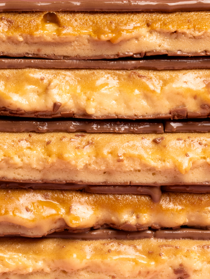 A close-up stack of five Barebells Gingerbread soft bars cut in half.