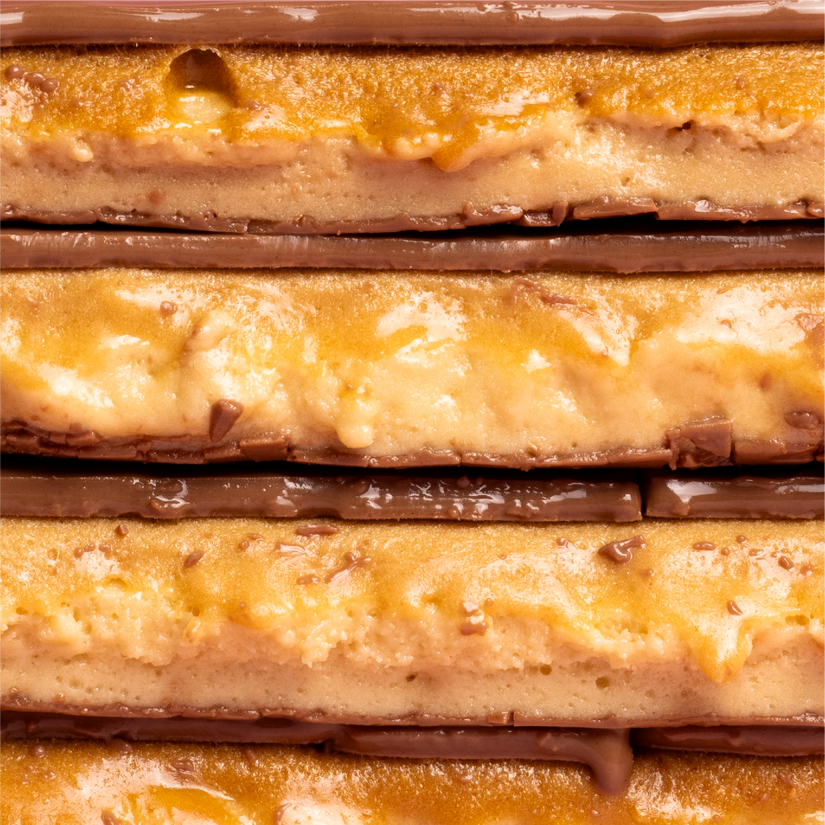 A close-up stack of five Barebells Gingerbread soft bars cut in half.